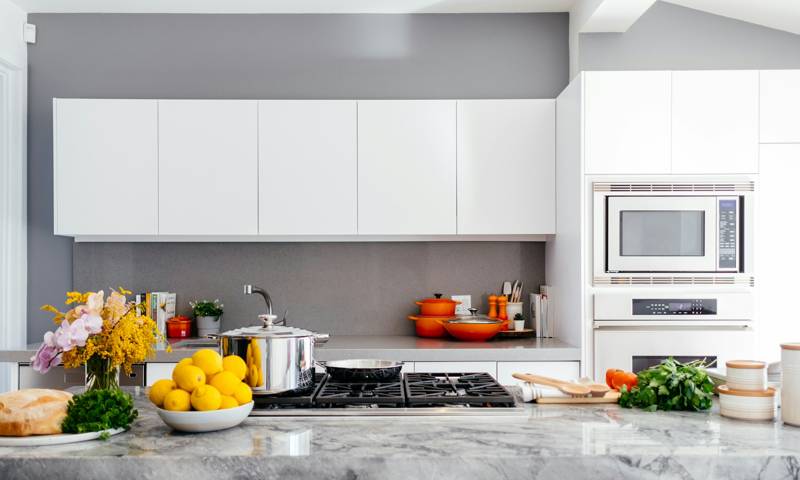 White shaker kitchen cabinets installed along a wall