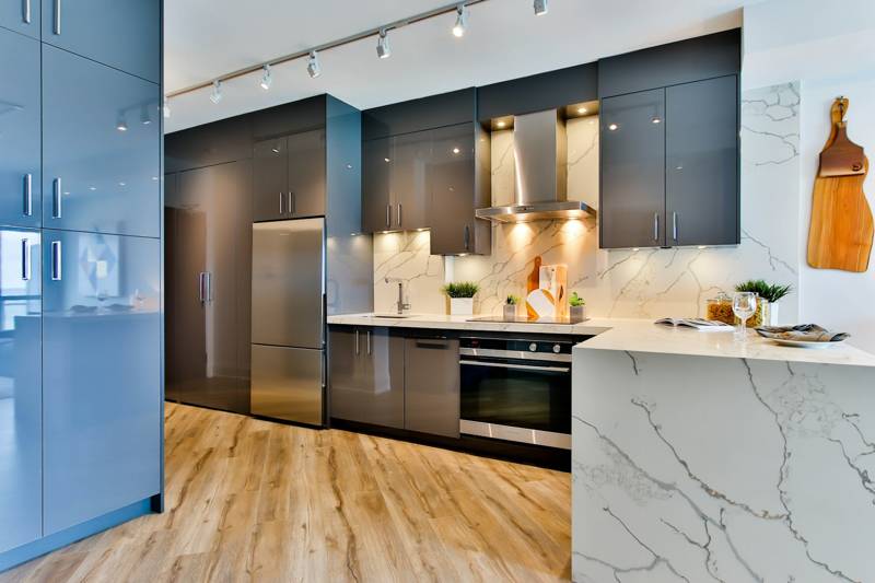 Blue kitchen cabinets with installed pulls
