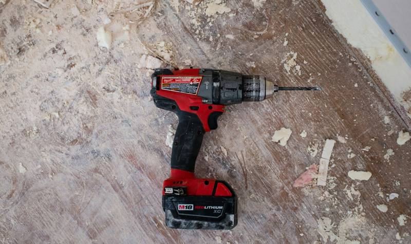 Cordless drill on a job site floor