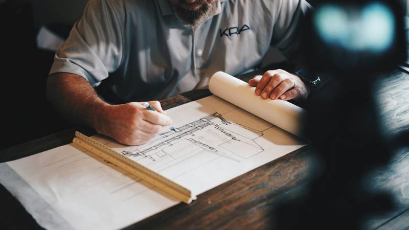 Construction plans and a pencil on a work table